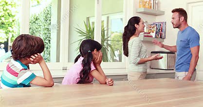 Couple arguing in front of children