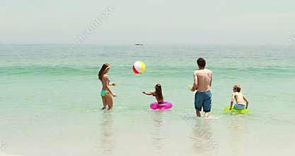 Happy family playing in water