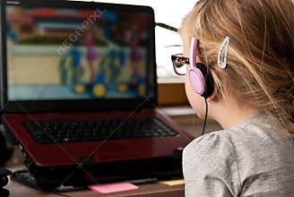 Young girl looking at laptop screen