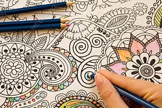Adult colouring books with pencils, new stress relieving trend, mindfulness concept person coloring illustrative