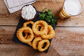Fried onion rings in batter with sauce