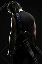 Man with guitar in the darkness
