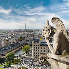 Gargoyle and city view from the roof of Notre Dame de Paris