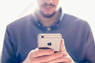 Businessman holding the new Apple iPhone 6s retina