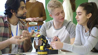 Students building a robotic arm