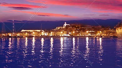 Ibiza Eivissa town sunset with city lights reflection in Mediterranean sea of balearic Islands