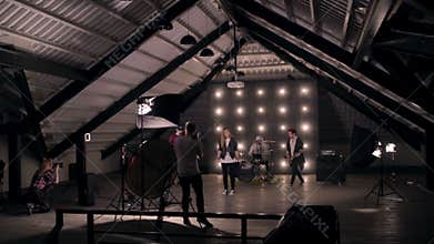 Behind the scenes. Rock band shooting a music video in studio.