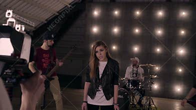 Behind the scenes. Rock band shooting a music video in studio.