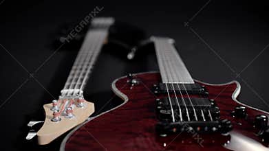 Red electric guitar and black bass, lie side by side.