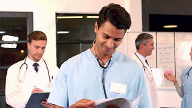Doctors writings things on clipboards