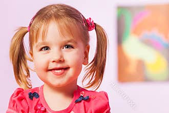 Happy and smiling portrait of girl with ponytails