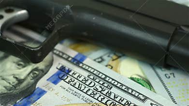 Gun on dollar bills