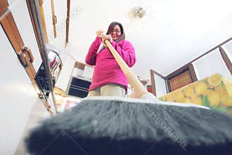 Cat's prospective. A woman drives away a cat from the kitchen.