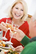Couple Toasting At Christmas Dinner