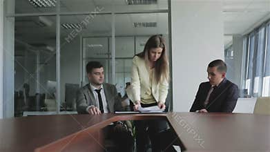 Young woman lawyer putting the signed documents in a black folder.