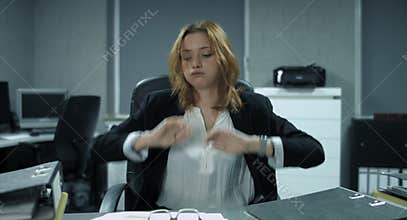 4K: A young employee is filing some documents in a modern office