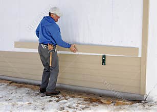 Carpenter installing siding
