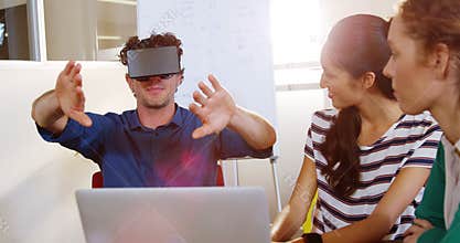 Businessman using virtual reality headset in meeting