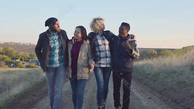 Happy diverse group walking on dirt path