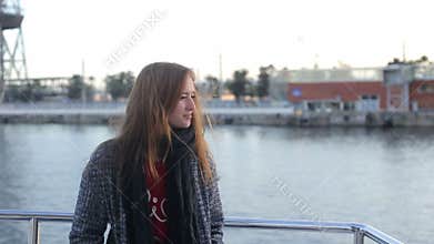 Happy girl dancing and singing on the sail boat