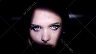 Pretty brunette woman with blue eyes artistic portrait