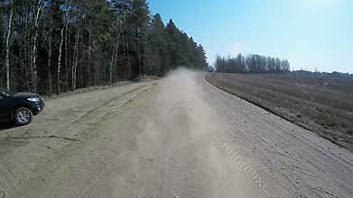 Country driving car on gravel road using a fisheye lens. Slow motion