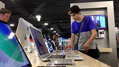 One side of people trying display Macbook computer