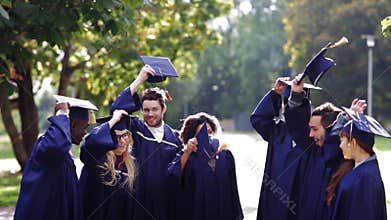 Happy students throwing mortar boards up