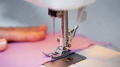 Sewing machine presser foot stitching fabric