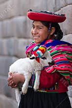 Native Peruvian holding a baby lamb