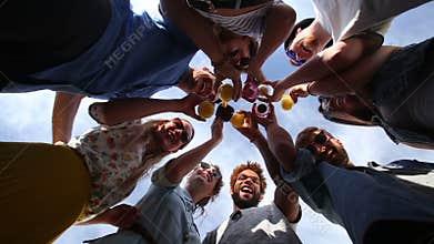 Group of eight happy friends looking down at camera and toasting