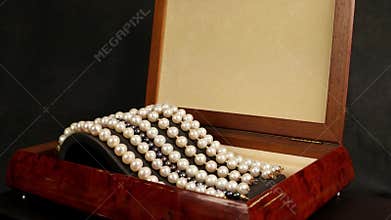 Pearl bracelets in brown wooden casket, jewelry made of pearls, Pearl bracelets on a pedestal decoration for glamorous