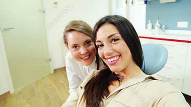 Close up of happy female patient with dentist