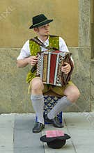 Young street performer, dressed in traditional bavarian clothes