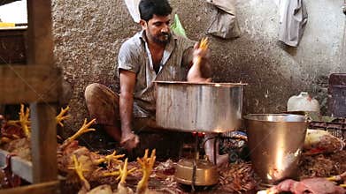 Indian man cleaning animal meat in Mumbai.