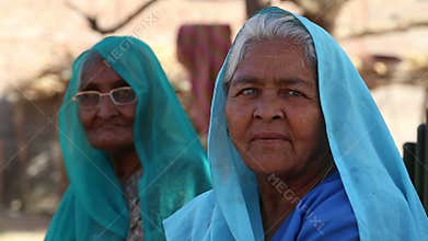 Portrait of two old Indian women in traditional colorful clothing.