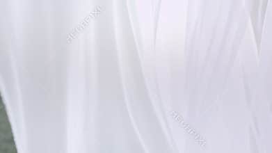 Sheer white curtains blowing in the wind