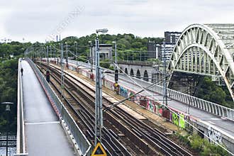 City landscape with train and pedestrian bridges.