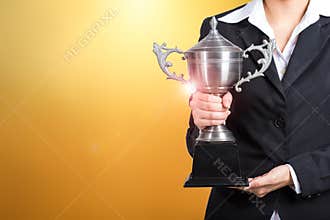 Businesswoman holding trophy award for success in business. gold