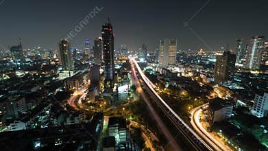 Time lapse shot of night life in the big city, lighted skyscraper, traffic, intersection, Bangkok, Thailand