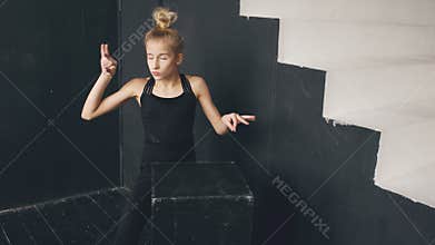 Modern beautiful teenage girl dancer perfomance contemporary dance in ballroom indoors