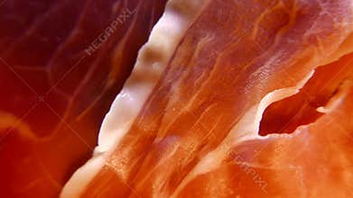 Extreme closeup of thin slices of delicious pork ham on the dish. 4K UHD