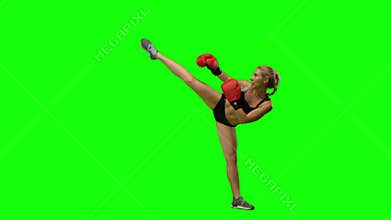 Girl kickboxer jumps up and makes swings and kicks. Green screen. Side view