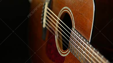 Acoustic guitar on wood background. Close up of music instrument