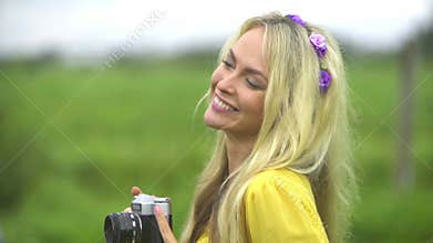 Attractive, beautiful, young girl taking pictures outdoors.