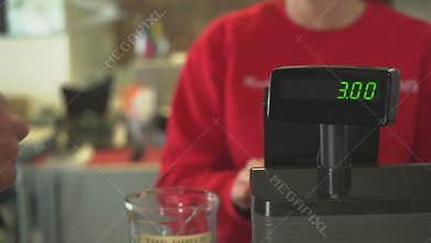 Female owner handles transaction at register