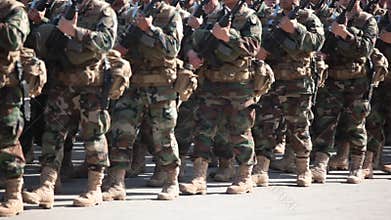 Soldiers in Camouflaged Uniform Marching