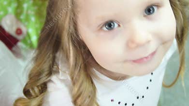 Little girl. The mother raises the girl`s hair