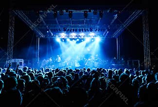 Crowd at concert under blue lights