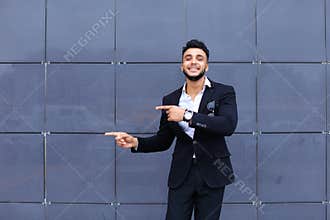 Arabic guy in business center stands smiling walking slow